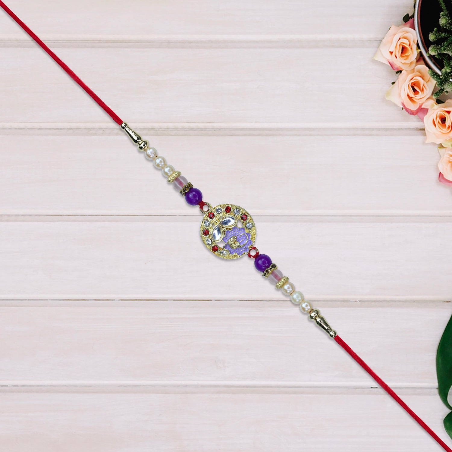 Elegant Ganesh Rakhi With Pearl And Purple Beads Elegant Ganesh Rakhi With Pearl And Purple Beads